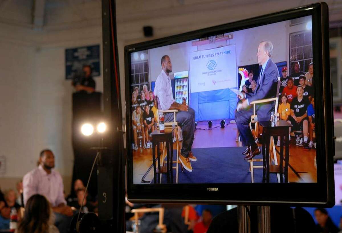 A flat-screen television was on the set at the Boys & Girls Club of Greenwich as the image of LeBron James being interviewed by Jim Gray, right, is shown, Thursday evening, July 8, 2010. James announced he will be playing for the Miami Heat next season at the press conference.