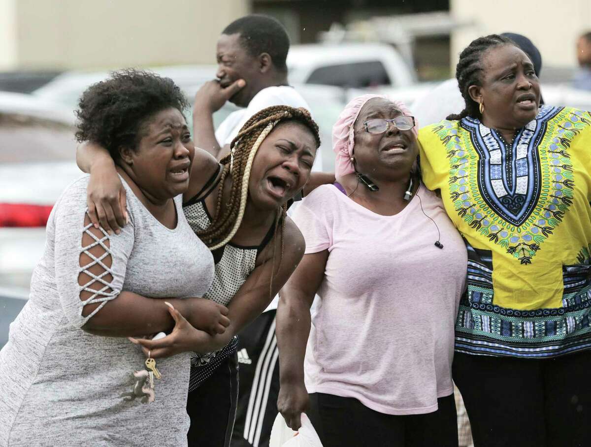 Neighbors and family members react to the news of two children, 1 and 8 years old, who were murdered in their father's apartment on Saturday, Aug. 4, 2018 in Houston.  Jean Pierre Ndossoka was charged with capital murder in the deaths.