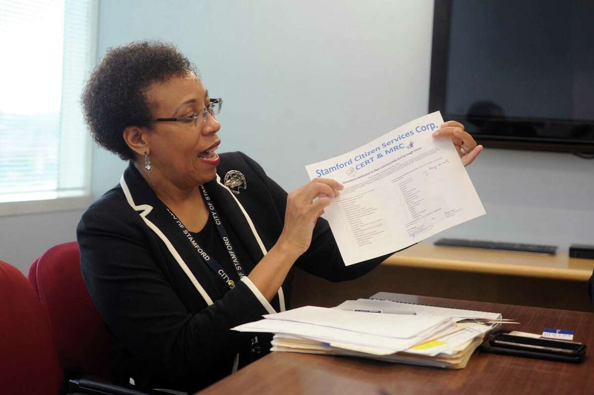 The Director of Health for the city of Stamford Dr. Jennifer Calder holds up a list of the various volunteer skills needed for the Stamford Citizen Services Corp. program inside Government Center in downtown Stamford, Conn. on Wednesday, Aug. 1, 2018.
