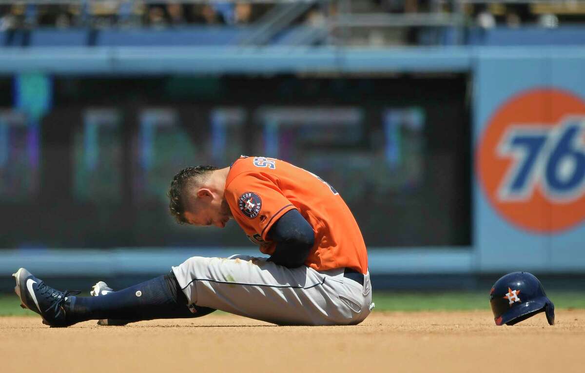LOS ANGELES, CA - AUGUST 05: George Springer #4 of the Houston Astros reacts to being injured after getting caught trying to steal second base in the third inning against the Los Angeles Dodgers at Dodger Stadium on August 5, 2018 in Los Angeles, California.
