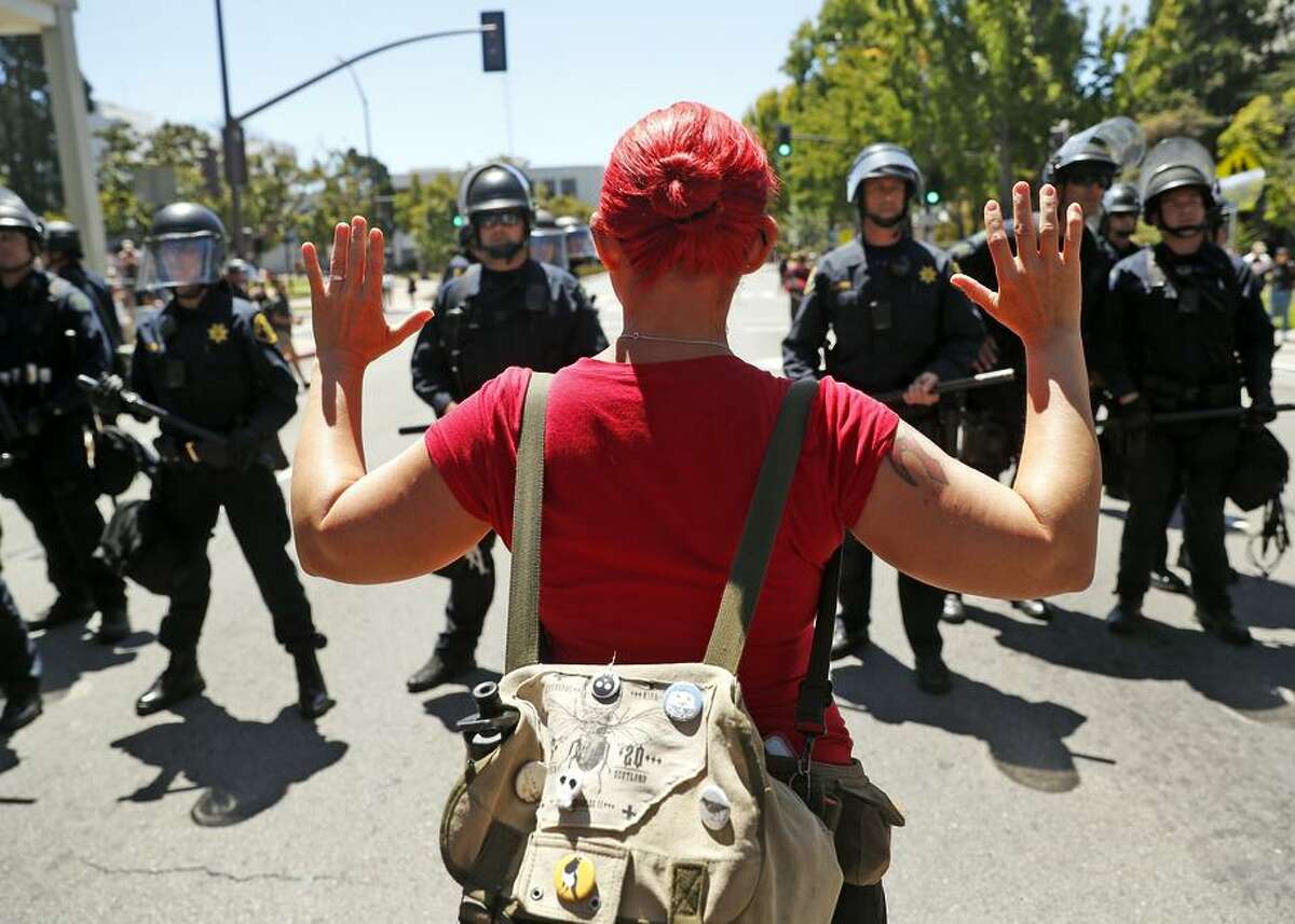 A counterprotester is stopped by Berkeley police just north of a gathering of the Proud Boys, a conservative group.