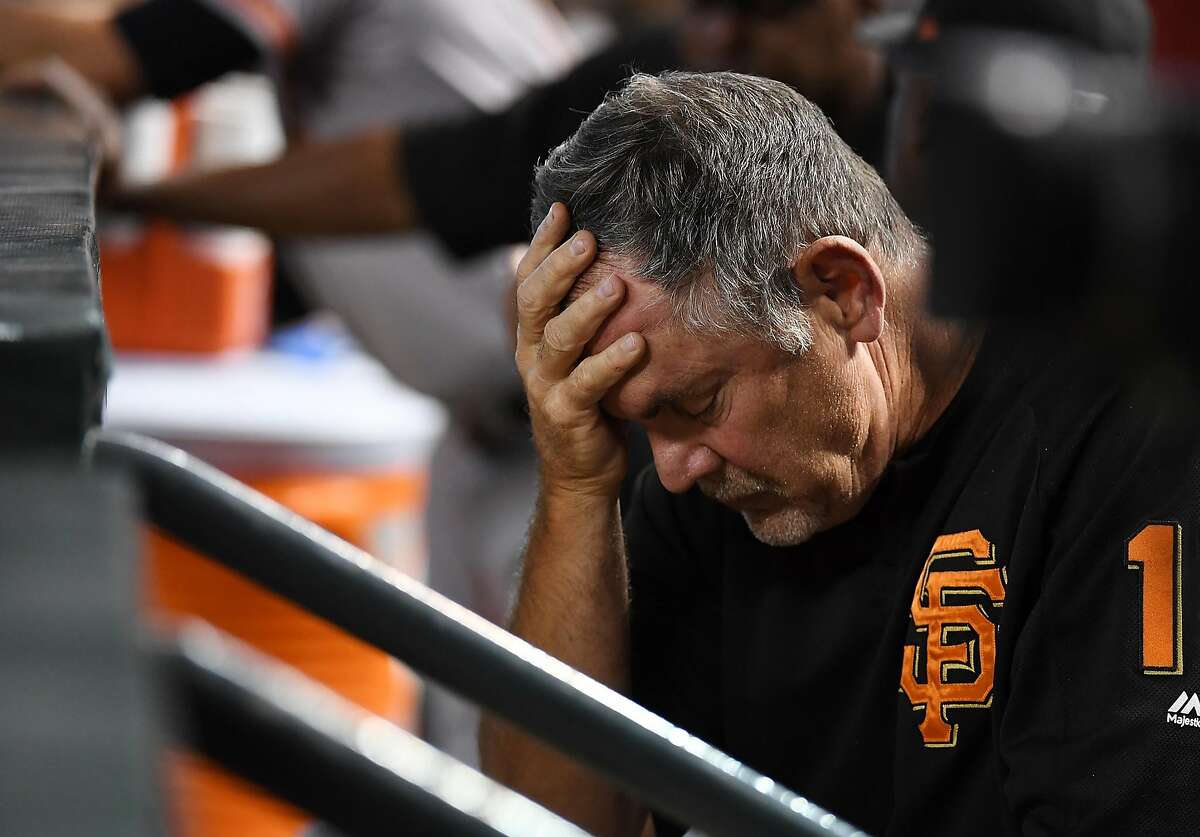 PHOENIX, AZ - AUGUST 05: Manager Bruce Bochy #15 of the San Francisco Giants rests his head in his hand while sitting in the dugout during the third inning of a game against the Arizona Diamondbacks at Chase Field on August 5, 2018 in Phoenix, Arizona. (Photo by Norm Hall/Getty Images)