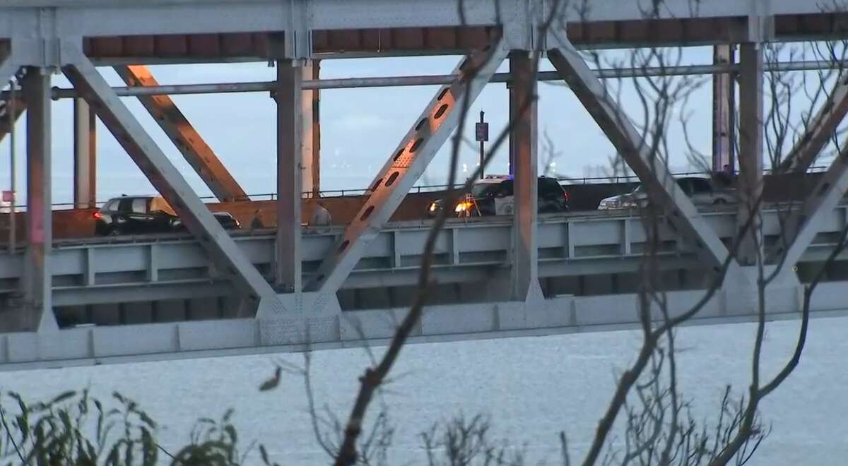 Police inspect the scene of a shooting on the Bay Bridge early Monday morning. The incident closed all eastbound lanes across the bridge.