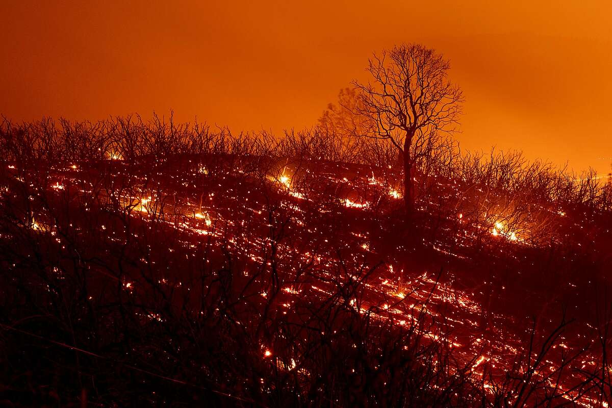 ***BESTPIX*** Embers smoulder along a hillside after the Ranch Fire, part of the Mendocino Complex Fire, burned though the area near Clearlake Oaks, California, on August 5, 2018. - Several thousand people have been evacuated as various fires swept across the state, although some have been given permission in recent days to return to their homes. (Photo by NOAH BERGER / AFP) (Photo credit should read NOAH BERGER/AFP/Getty Images)