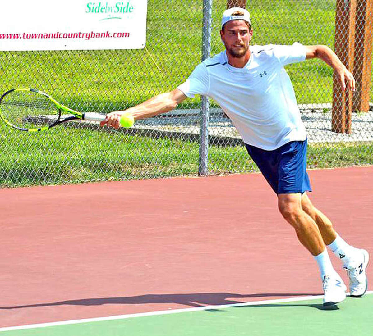 Maxime Cressy of France returns a shot on Monday during his Futures Qualifying Tourney singles match against Charles Broom of the UK at the Edwardsville High Tennis Center.