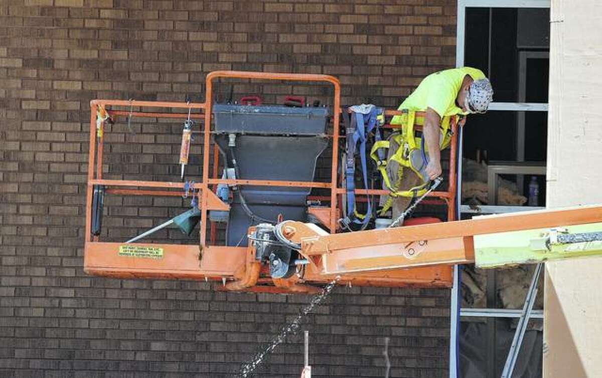 Construction crews work Monday to finish renovation projects at South Jacksonville Elementary School ahead of the start of the school year later this month.