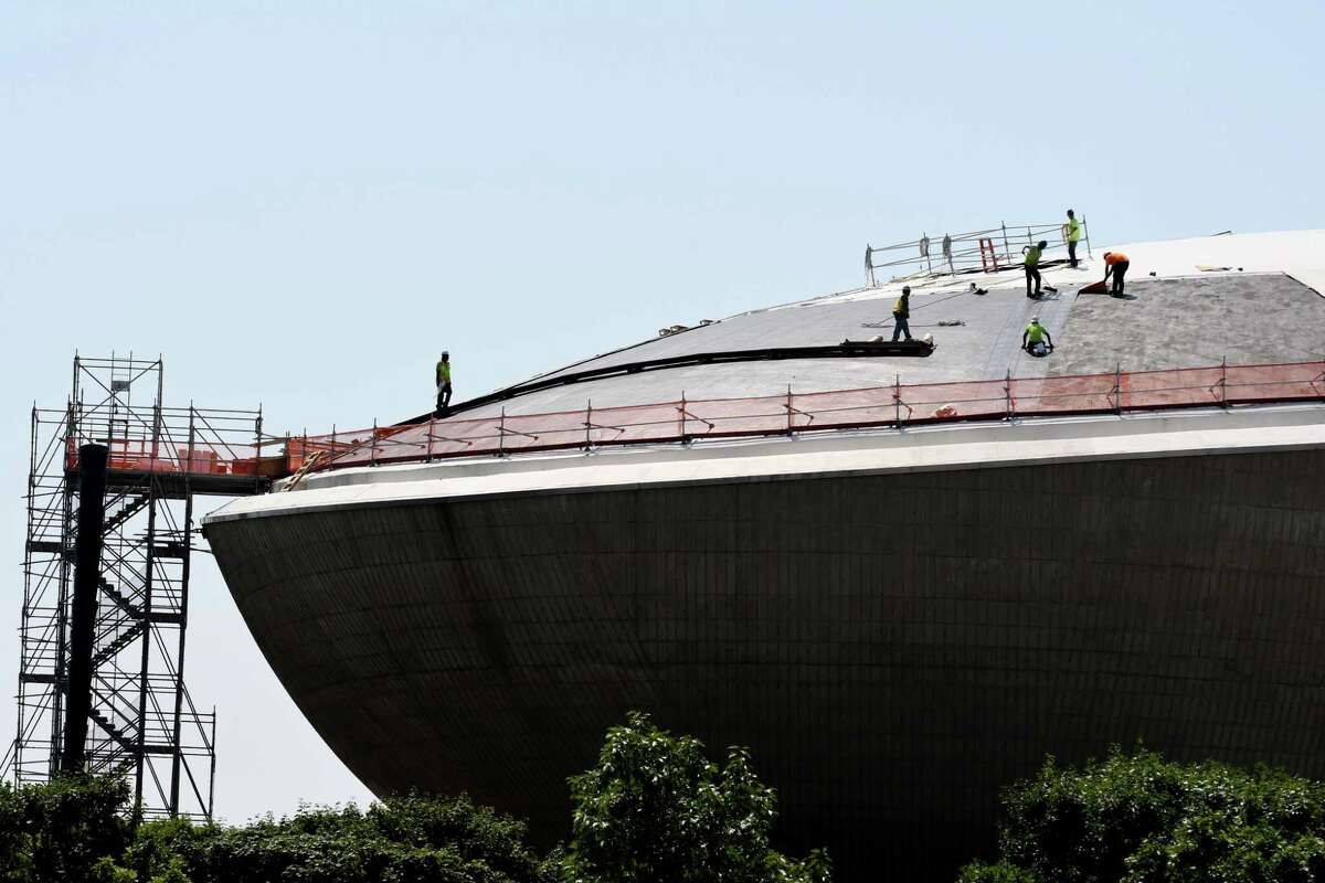 Workers replace the roof of The Egg on Monday, Aug. 6, 2018, at the Empire State Plaza in Albany, N.Y. The $4.4 million roof replacement project is expected to be completed next year. This is the first time the roof has been replaced since the facility opened in 1978. (Will Waldron/Times Union)