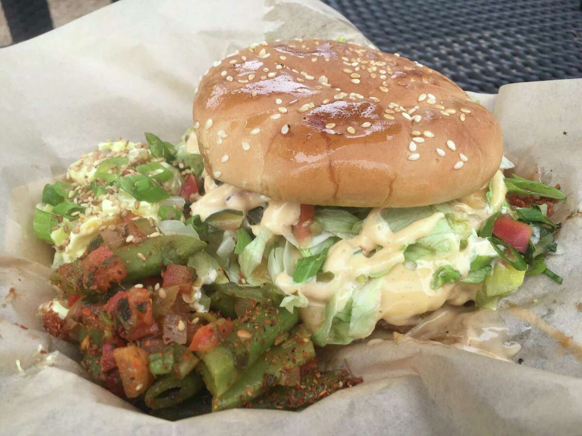 The Monster Chicken Fried Cheeseburger at the Guerrilla Gourmet food truck sells for $10 and includes two side items. It's an 8 ounce patty topped with shredded lettuce, "pickle de gallo," cheese gravy, jalapeños, the special house "guerilla sauce."