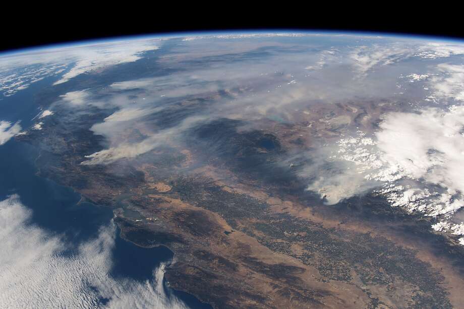 In a photo provided by the astronaut Alexander Gerst of the European Space Agency, seen from the International Space Station, plumes of smoke from various wildfires burn in northern California, on Aug. 2, 2018. The largest wildfire in California’s history continued to rage Aug. 7, after steadily growing for nearly two weeks. Unprecedented in scope, the Northern California fire, called the Mendocino Complex, has already consumed roughly 980 square miles and forced tens of thousands of people from their homes. (Alexander Gerst/European Space Agency via The New York Times) -- FOR EDITORIAL USE ONLY. -- Photo: ALEXANDER GERST / NYT