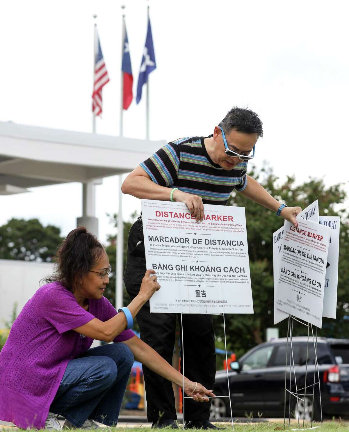 Kyle Fu, right, and Kathy Huynh set up a voting location at the West Gray Metropolitan Multi-Services Center Tuesday, Aug. 7, 2018, in Houston.