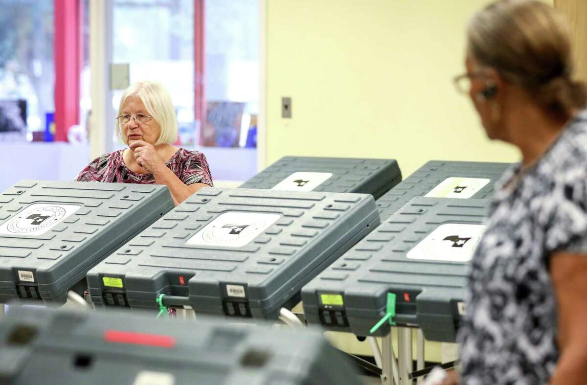 Mae Huckabay, left, works to set up a voting location at the West Gray Metropolitan Multi-Services Center Tuesday, Aug. 7, 2018, in Houston.