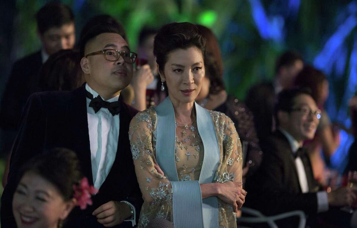 Nick Santos as Oliver and Michelle Yeoh as Eleanor in Warner Bros. Pictures' and SK Global Entertainment's and Starlight Culture's contemporary romantic comedy "CRAZY RICH ASIANS," a Warner Bros. Pictures release.