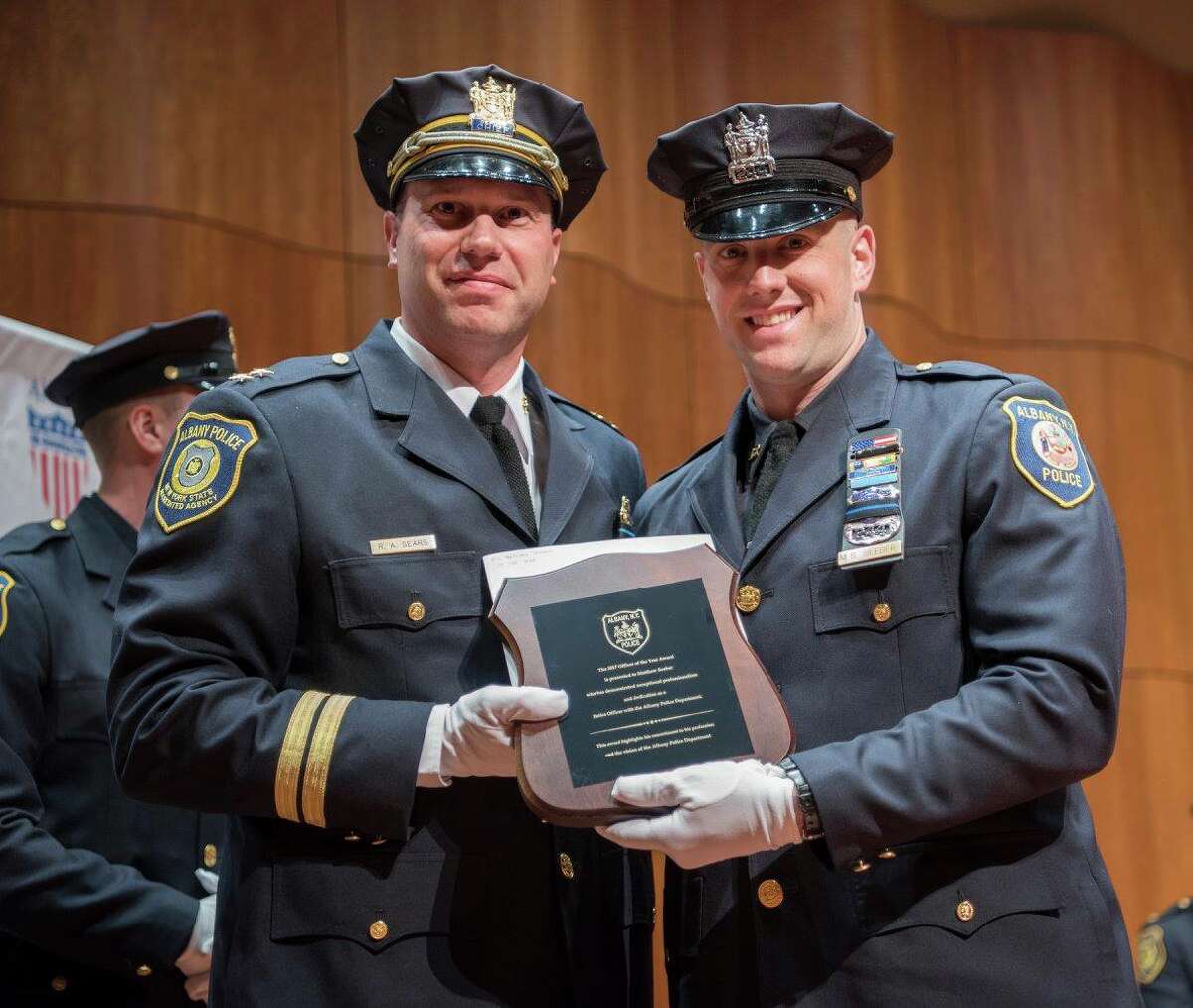 Matthew Seeber, right, receives the Officer of the Year Award from the Albany Police Department on May 15, 2018.