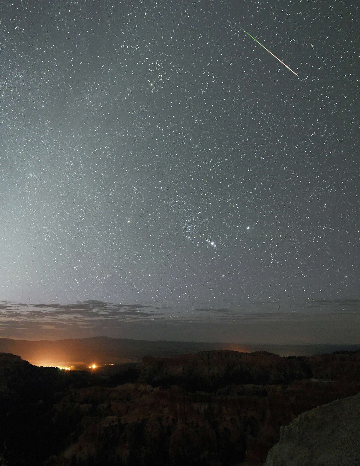 FILE-- A Perseid meteor streaks across the sky above Inspiration Point early on August 12, 2016 in Bryce Canyon National Park, Utah. A new paper by a trio of Harvard University researchers argues that we all might be immigrants from deep space, brought to Earth via a mechanism called panspermia.