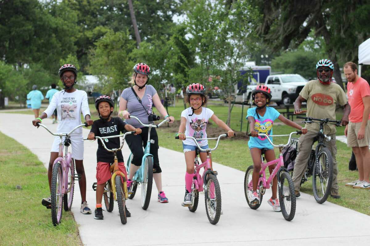 A group takes a bike ride during Bayou Greenway Day. The Bayou Greenways 2020 project will create and connect 150 miles of hiking and biking trails.