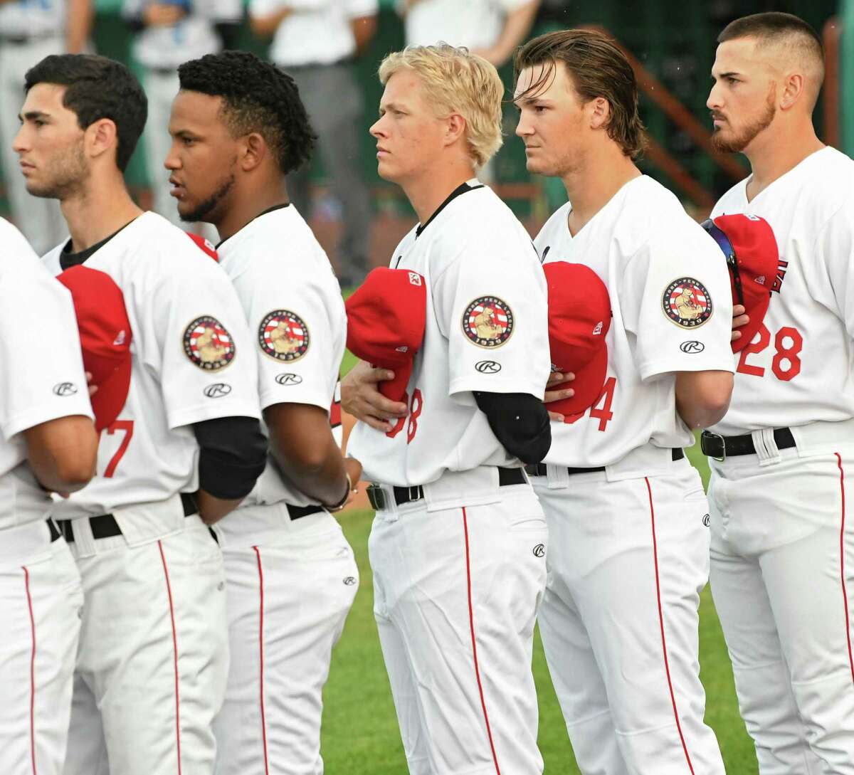 Tri-City ValleyCats pitcher Austin Hansen, center, listens to the National Anthem during a baseball game against the Hudson Valley Renegades at Joe Bruno Stadium on Wednesday, Aug. 8, 2018 in Troy, N.Y. (Lori Van Buren/Times Union)