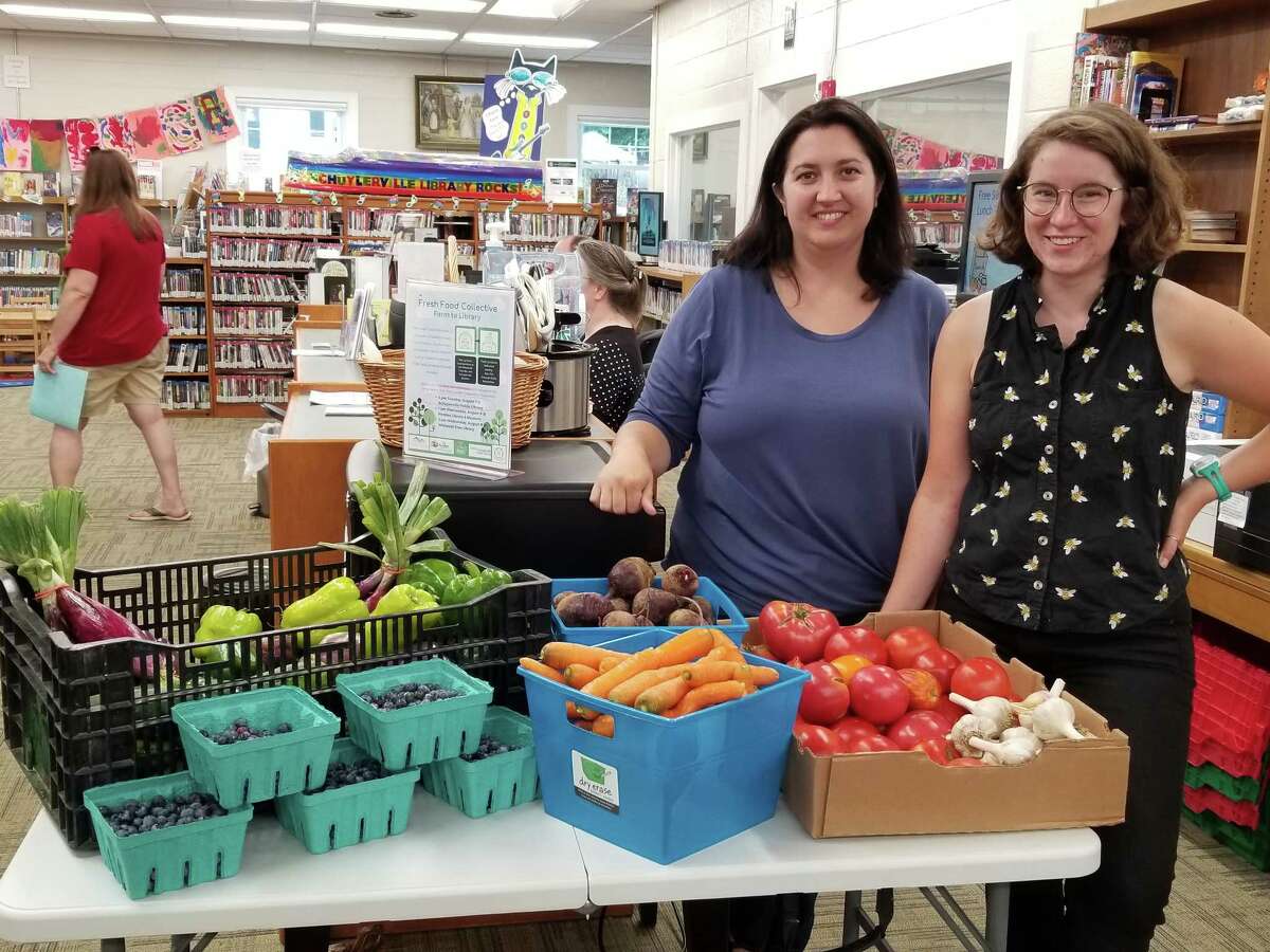 Caitlin Johnson (left) and Lillian Slaughter pose with fresh produce at the Schuylerville Public Library on Tuesday, Aug. 7, to celebrate the launch of Fresh Food Collective Library Distribution. (Submitted photo)