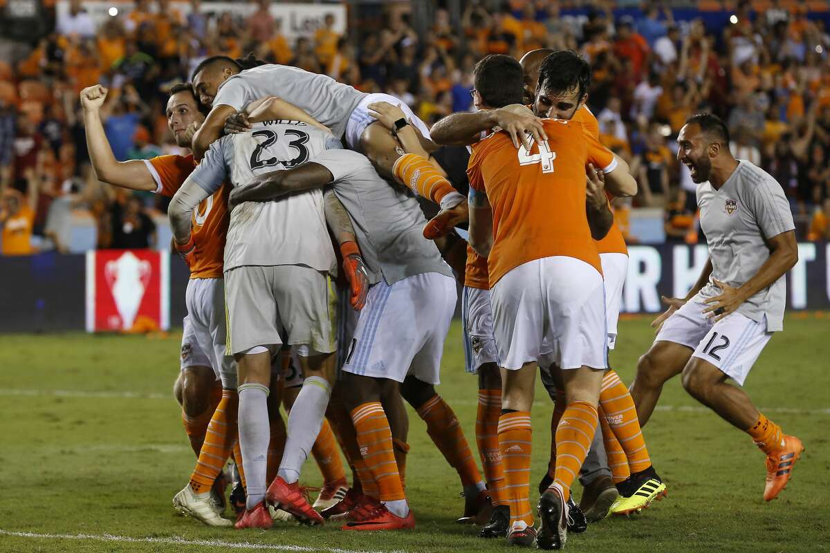 Houston Dynamo goalkeeper Joe Willis (23) is mobbed by his teammates after making the winning save to defeat LA during the 2018 Lamar Hunt U.S. Open Cup Semi-Finals Wednesday, Aug. 8, 2018, in Houston.
