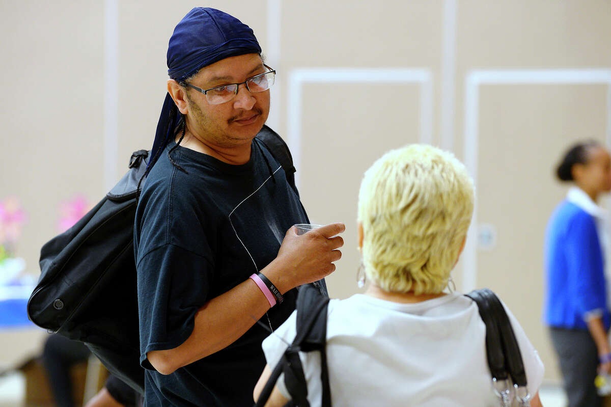 Donald Delasbour talks with another attendee during the Spindletop Center's Healing After Harvey event at Port Arthur's Bowers Civic Center. Delasbour said he's sleeping on his sister's couch while repairing his Port Arthur home. Photo taken Tuesday 8/7/18 Ryan Pelham/The Enterprise