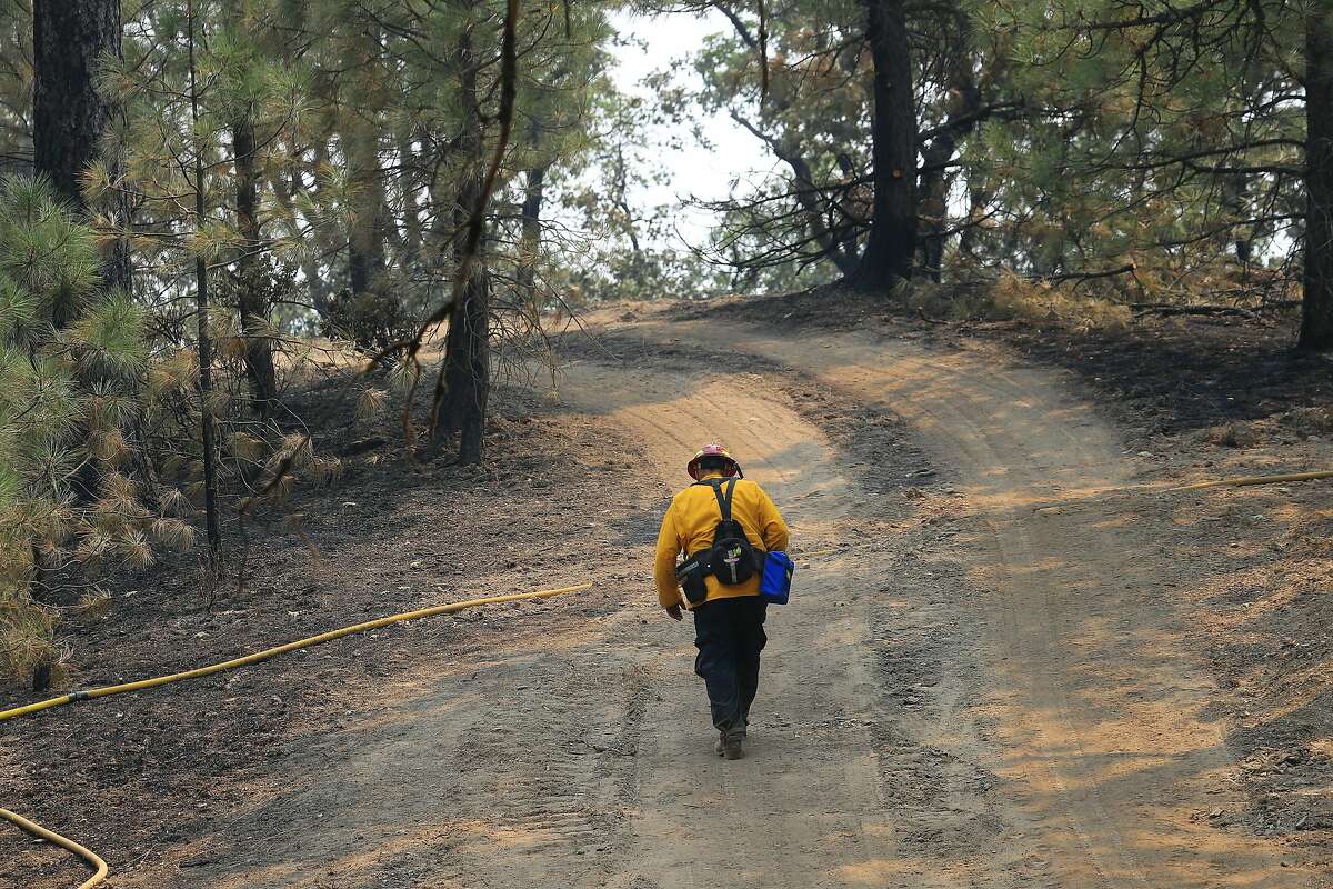 A firefighter hikes up a trail in an area burned by the Ranch fire around Clearlake, Calif., Aug. 8, 2018. The Mendocino Complex fire system, a combination of the Ranch fire and the River fire, has grown to more than 300,000 acres. Billowing smoke from the historic wildfire season has caused hazardous air conditions across the state, prompting air quality alerts and forcing many residents to take refuge indoors to avoid unhealthy exposure to bad air. (Jim Wilson/The New York Times)