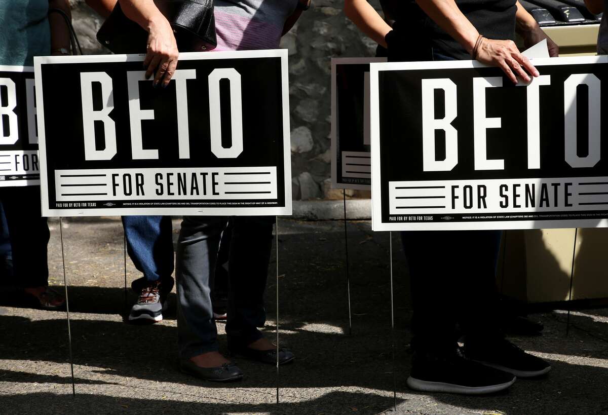 Beto O'Rourke supporters hold campaign signs as they listen to his speech at the "Menudo with Beto" event Sunday, July 29, 2018, in El Paso, Texas.