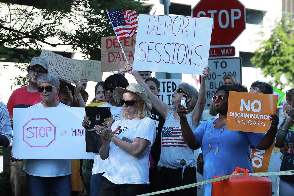 Several dozen protesters gather across the street from the U.S. Attorney's Office for the Middle District of Georgia during a visit by Attorney General Jeff Sessions on Thursday, Aug. 9, 2018, in Macon, Ga. (Curtis Compton/Atlanta Journal-Constitution/TNS)