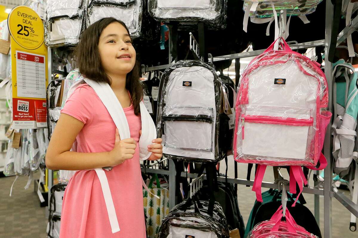 Scarlet Cardenas, 9, a fourth-grader at Bulverde Creek Elementary, tries on a clear backpack at OfficeMax, 17700 US Hwy 281 N, on Thursday, Aug. 9, 2018. NEISD has mandated that all student backpacks be clear at every high school and middle school in the district beginning in the fall of the 2018-2019 school year.