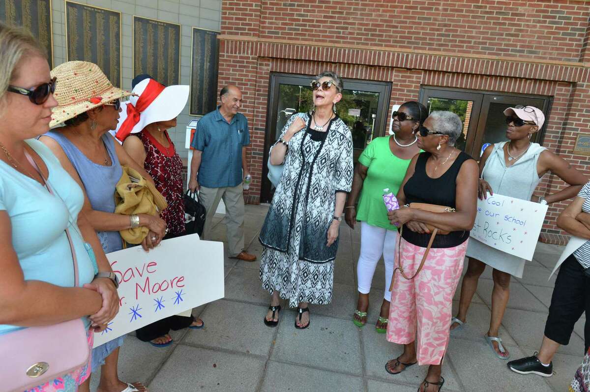 West Rocks School Principal Lynne Moore leaves city hall and lets supporters know she has been reassigned as a Housemaster at Norwalk High School on Thursday August 9, 2018 in Norwalk Conn.
