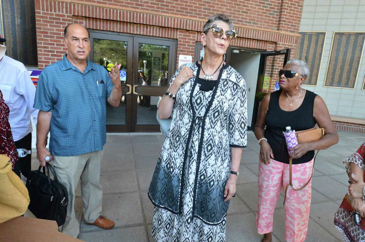 West Rocks School Principal Lynne Moore leaves city hall with Tony Ditrio Norwalk Association of School Administrators President, and lets supporters know she has been reassigned as a Housemaster at Norwalk High School on Thursday August 9, 2018 in Norwalk Conn.