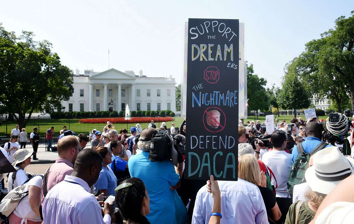 Protesters hold up signs during a rally supporting Deferred Action for Childhood Arrivals, or DACA, outside the White House on September 5, 2017. (Olivier Douliery/Abaca Press/TNS)
