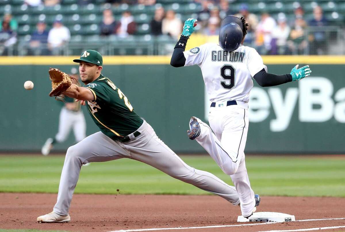 Seattle’s Dee Gordon beats the throw to A’s first baseman Matt Olson in a game the Mariners won 6-3 on May 1. The Mariners and A’s begin a three-game series at the Coliseum on Monday.