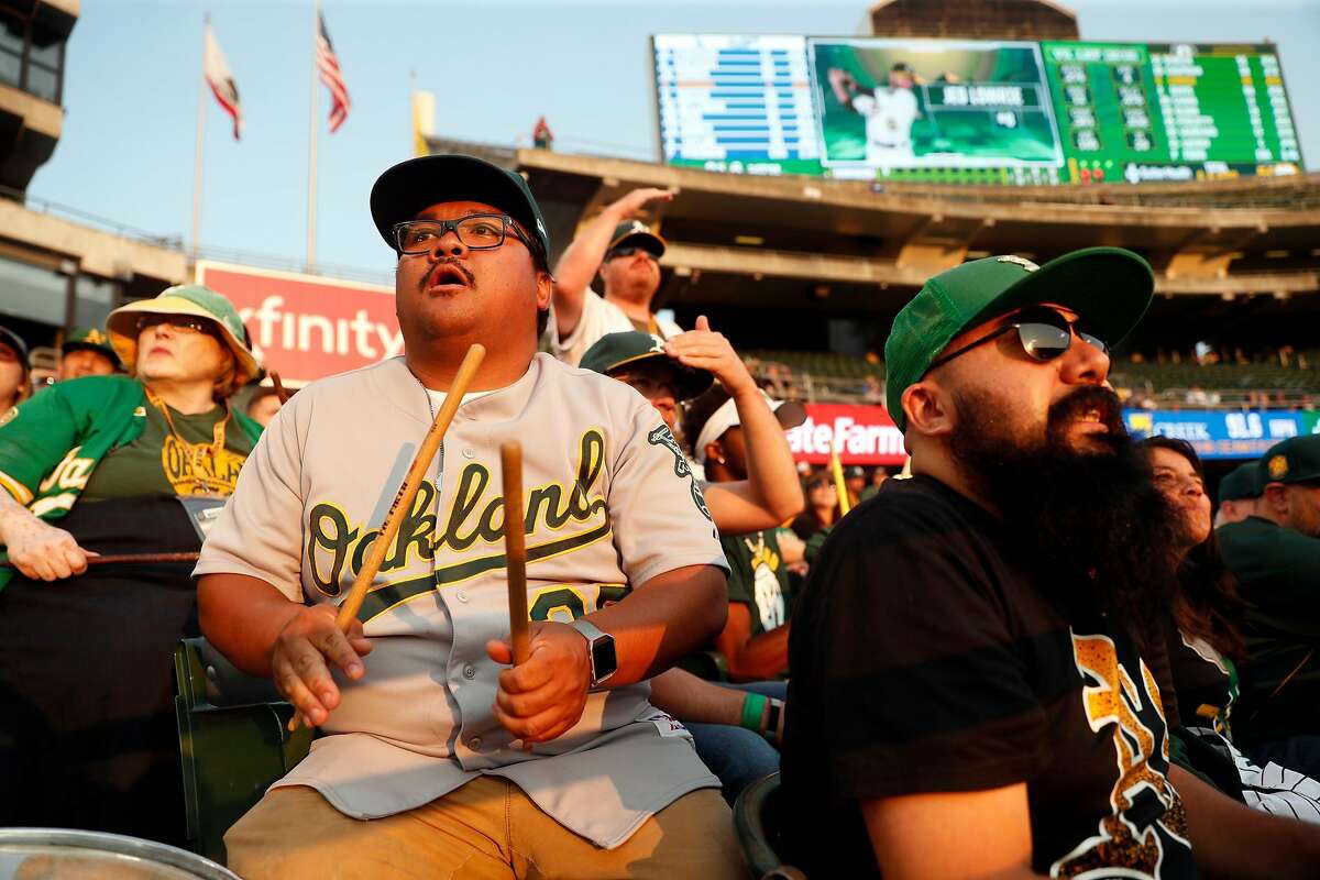 Oakland Athletics' fans Bryanne Aler-Ninges of Pittsburg watches the A's play the Los Angeles Dodgers from right field bleachers at Oakland Coliseum in Oakland, Calif. on Wednesday, August 8, 2018.