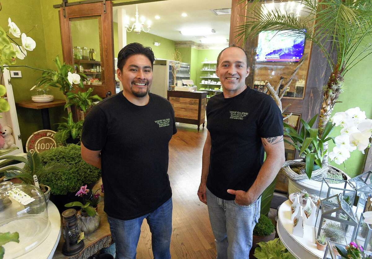 Co-owners Marcial Perez-Saunders, left, and Iris Oliveira stand in their new Verde Galerie florist-coffee shop at 79 Atlantic St., in downtown Stamford, Conn., on Aug. 1, 2018.