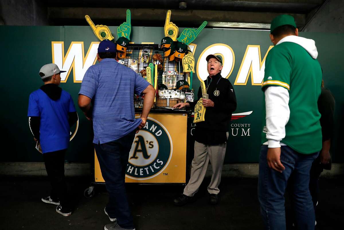 Oakland Athletics' vendor Tim Begley, who has worked at the Oakland Coliseum for the past 39 years, hawks programs and souvenirs before A's game against the Los Angeles Dodgers in Oakland, Calif. on Wednesday, August 8, 2018.