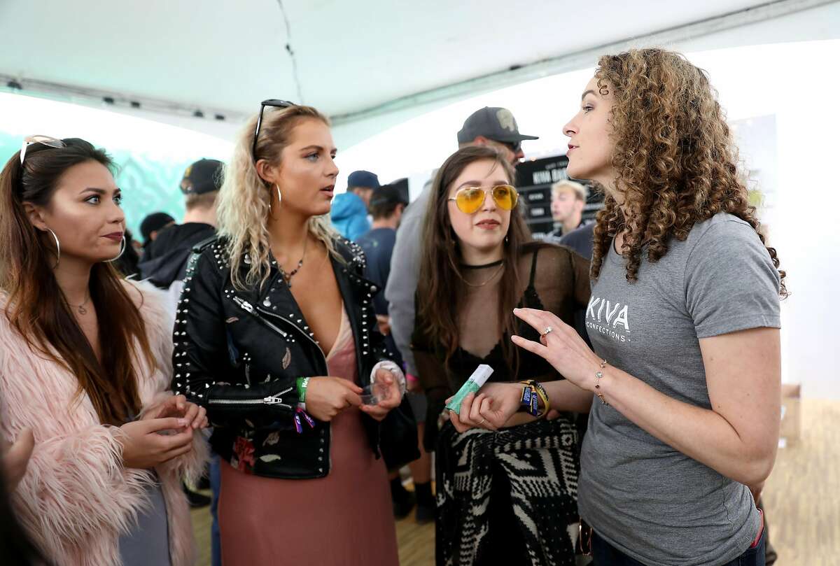 (Left to right) Brianna Stuppy, Kaylin Halleran, and Sierra Castro listen as Kristi Knoblich Palmer, Kiva Confections co-founder, talks to them about her products inside the Grass Lands area at Outside Lands at Golden Gate Park in San Francisco, Calif., on Friday, August 10, 2018. Grass Lands is the first marijuana exhibit at a major music festival.