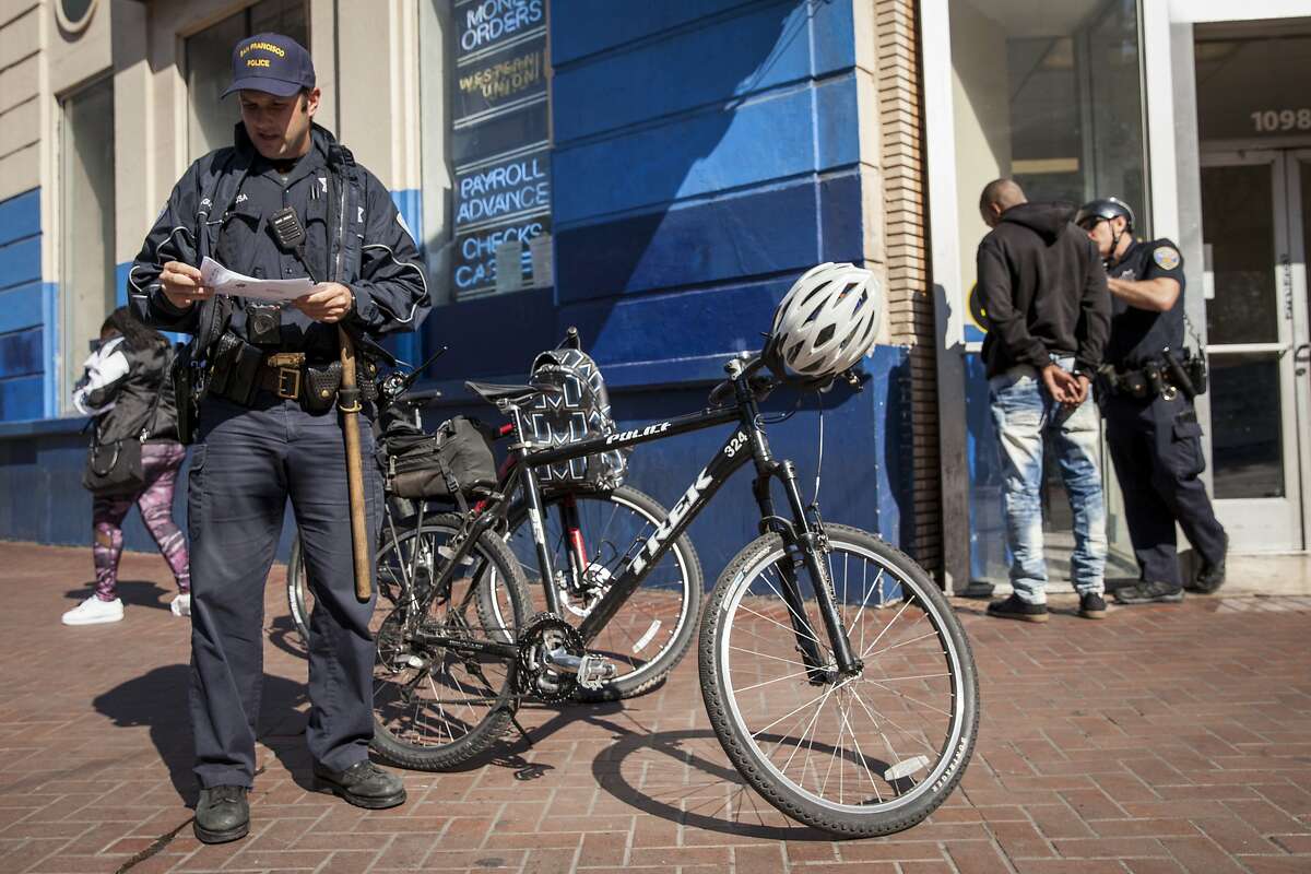 San Francisco beat cops on bicycles detain an unidentified individual along Market Street during their patrols of the Mid-Market Street area. A large increases in spending from the recently enacted $11 billion budget will go to foot and bicycle patrols, Friday 10 August 2018 in San Francisco, CA.