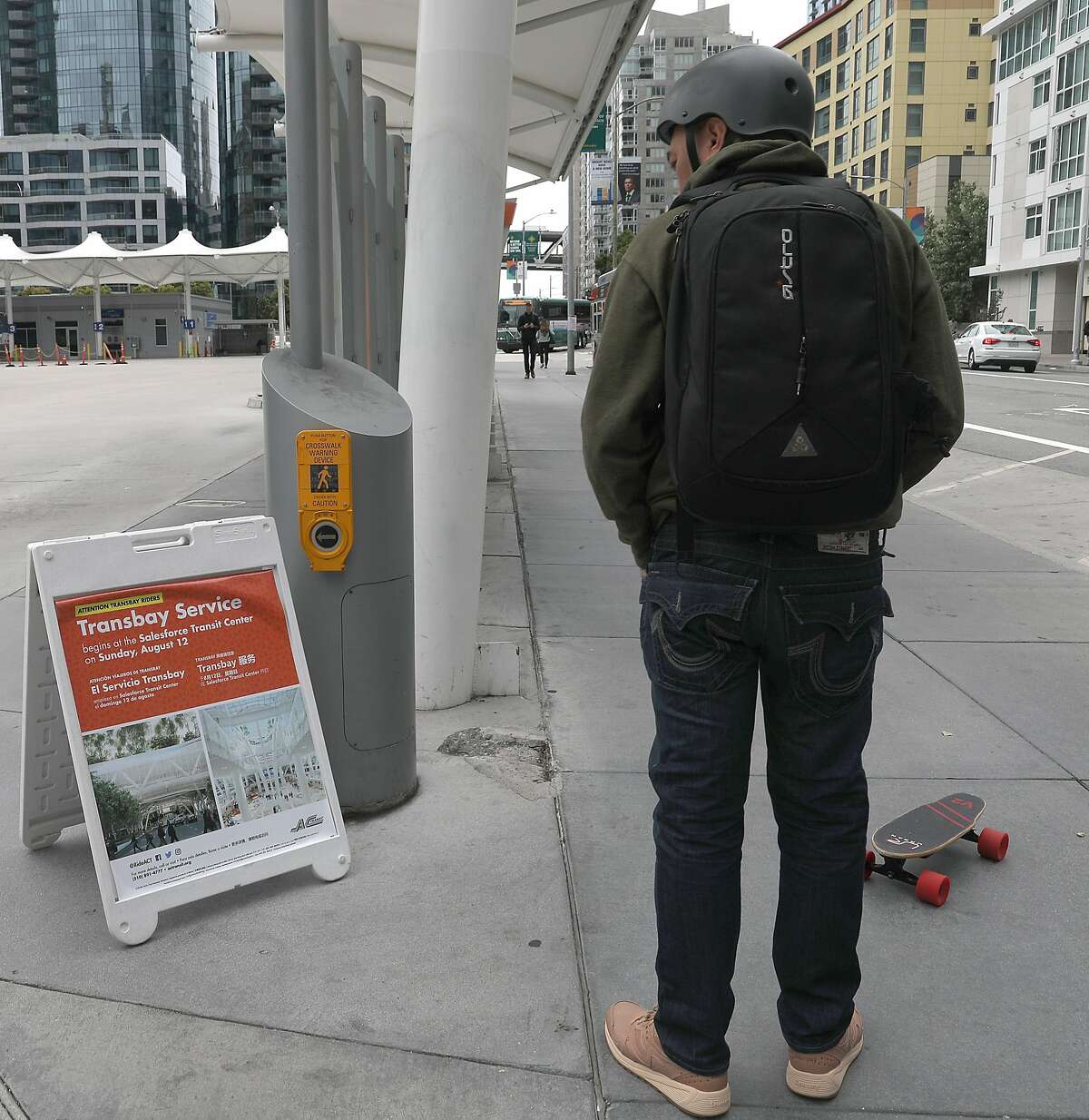 John Diamonon commuting from Union City reads about the moving schedule of The Temporary Transbay Terminal which is going to become a park and affordable housing after the new terminal opens after today on Wednesday, Aug. 8, 2018 in San Francisco, Calif.