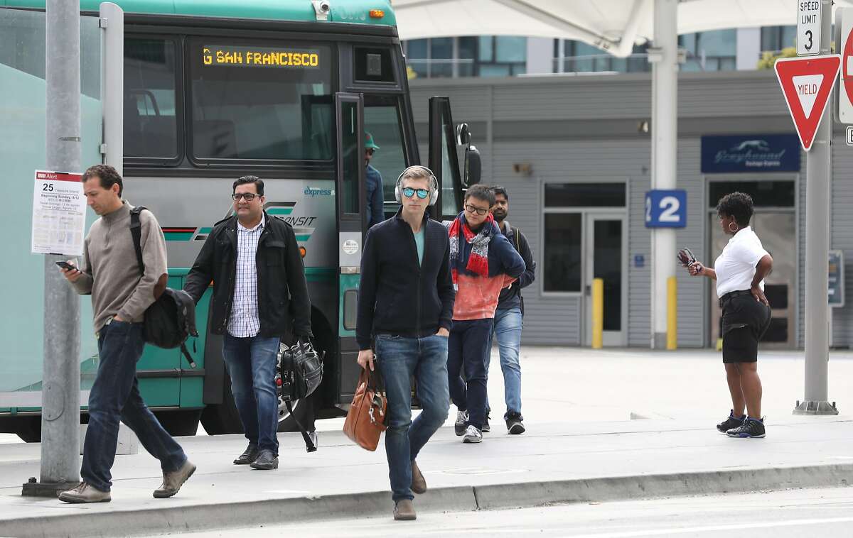 Passengers pass by The Temporary Transbay Terminal which is going to become a park and affordable housing after the new terminal opens on Wednesday, Aug. 8, 2018 in San Francisco, Calif.