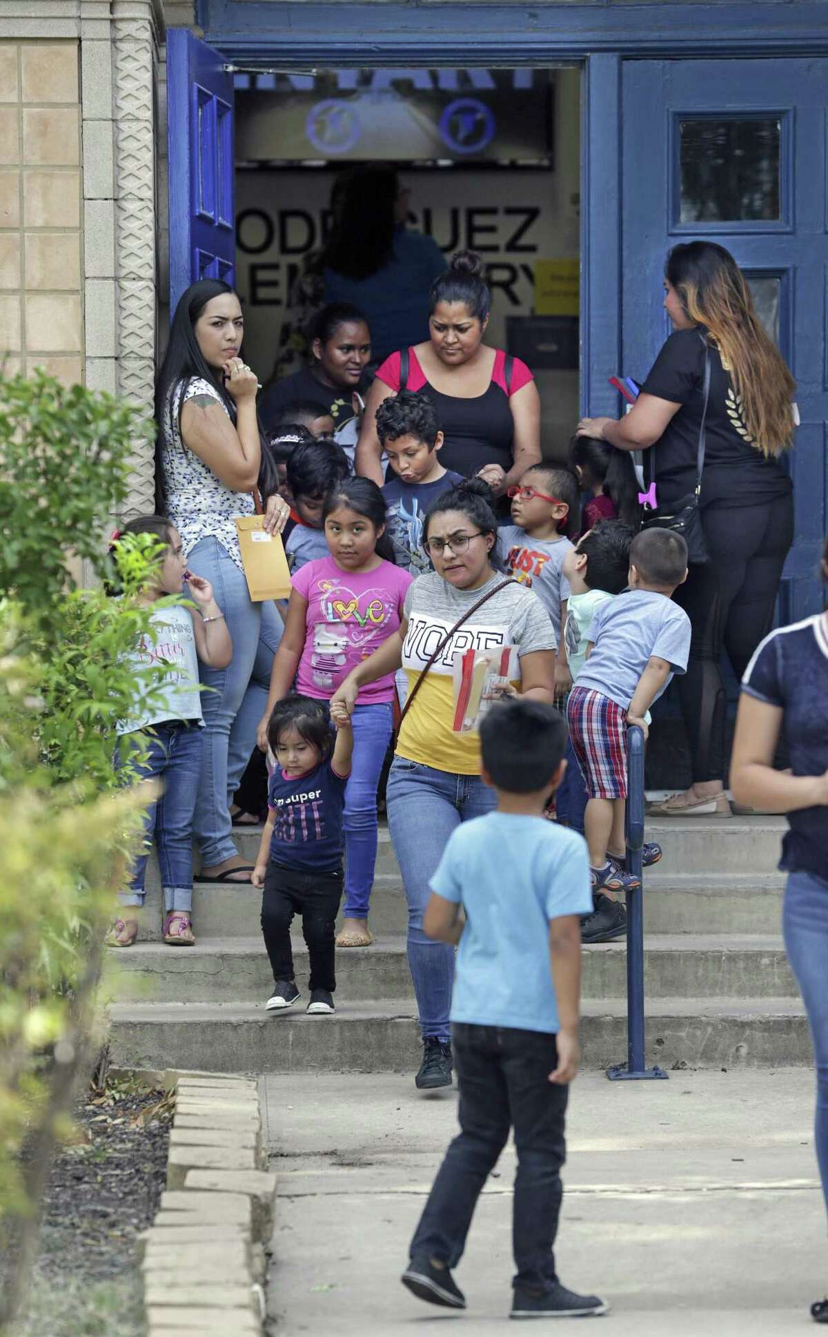 Kids leave Cleto Rodriguez Elementary School last week after visiting with parents to meet their teachers. SAISD officials will close the school next year, however, because it failed state accountability ratings five years in a row.