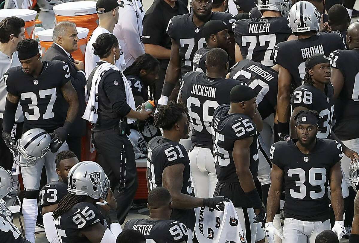 Oakland Raiders running back Marshawn Lynch, center left, sits near the sideline just before the national anthem at an NFL preseason football game between the Raiders and the Detroit Lions in Oakland, Calif., Friday, Aug. 10, 2018. Lynch remained seated for the anthem. (AP Photo/Jeff Chiu)