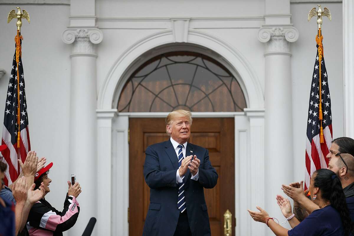 President Donald Trump arrives to greet cheering members of Bikers for Trump and supporters, Saturday, Aug. 11, 2018, at the clubhouse of Trump National Golf Club in Bedminster, N.J. (AP Photo/Carolyn Kaster)