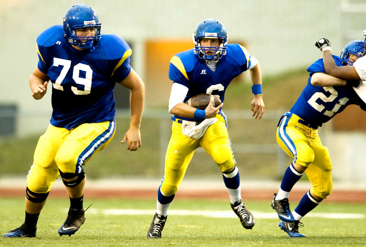 Midland High's Andrew Wylie (left) and Toby Wilson block for quarterback Alex Rapanos against Flint Southwestern in this 2010 Daily News file photo.