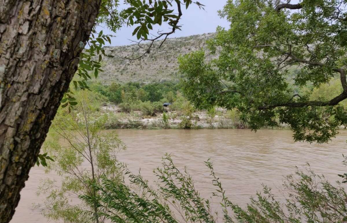 A pickup truck can be seen stranded on an island after heavy rains overnight and Sunday morning, August 12, 2018, caused the Nueces River to swell. Over two dozen people were rescued, according to the Uvalde County Sheriff's Office, and no serious injuries were reported.
