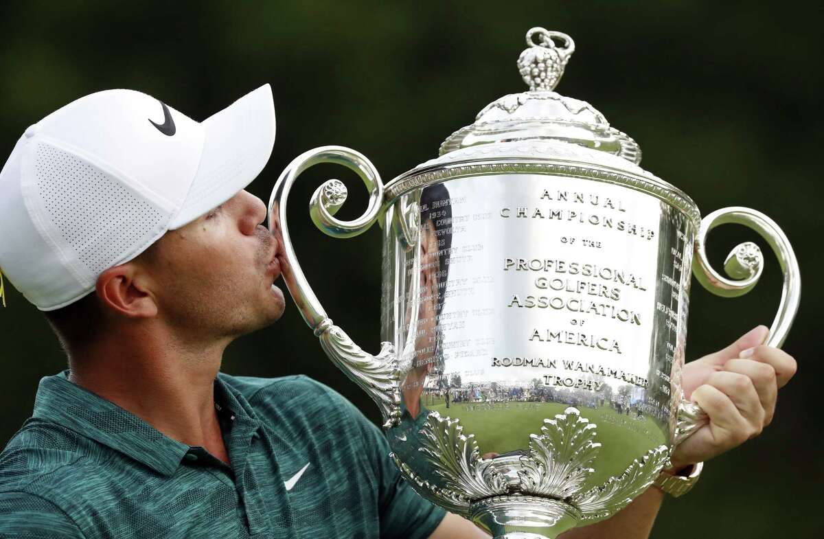 Brooks Koepka kisses the Wanamaker Trophy after he won the PGA Championship golf tournament at Bellerive Country Club, Sunday in St. Louis.