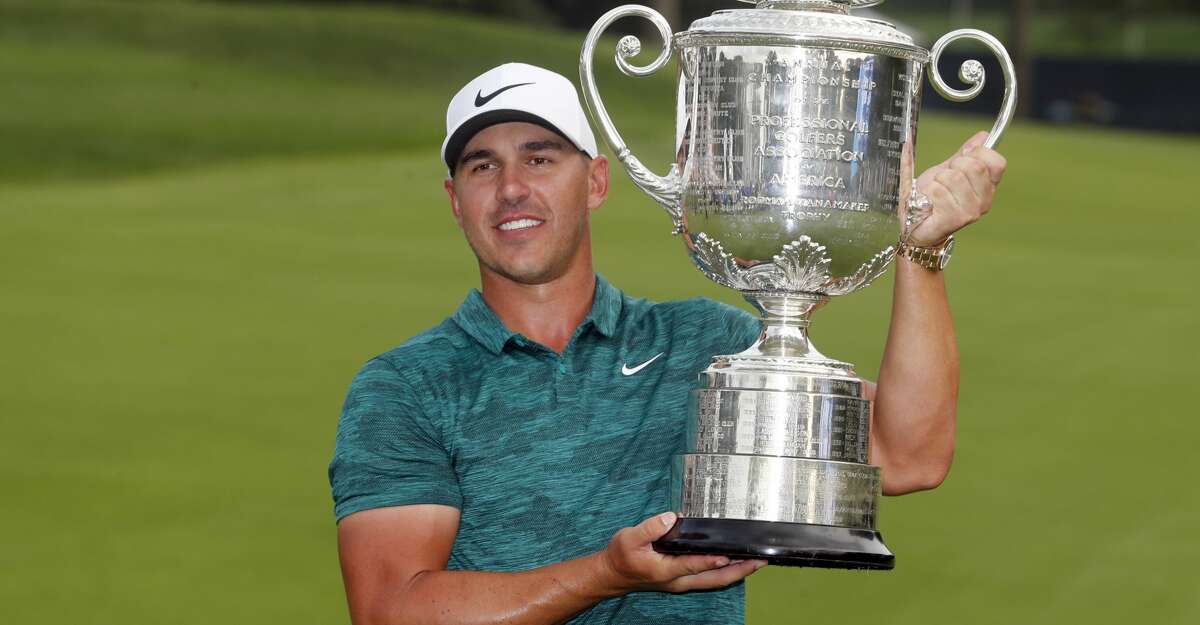 Brooks Koepka poses with the Wanamaker Trophy after winning the PGA Championship golf tournament at Bellerive Country Club, Sunday, Aug. 12, 2018, in St. Louis. (AP Photo/Jeff Roberson)