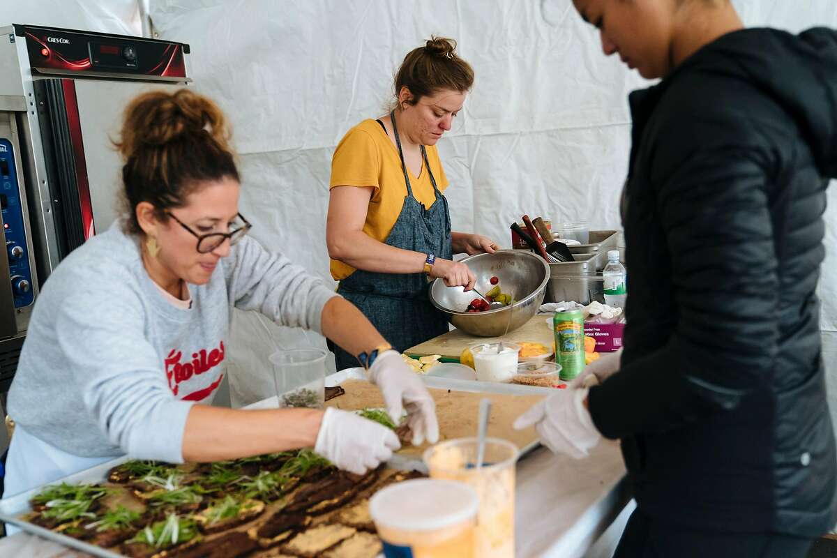 Chef Christa Chase, center, at Tartine Manufactory and the Zeina Razek and Grace Wang prepares food for a wine and food pairing with Eric Wareheim and Joel Burt at Outside Lands Music and Arts Festival at Golden Gate Park in San Francisco, Calif., on Sunday, Aug. 12, 2018.