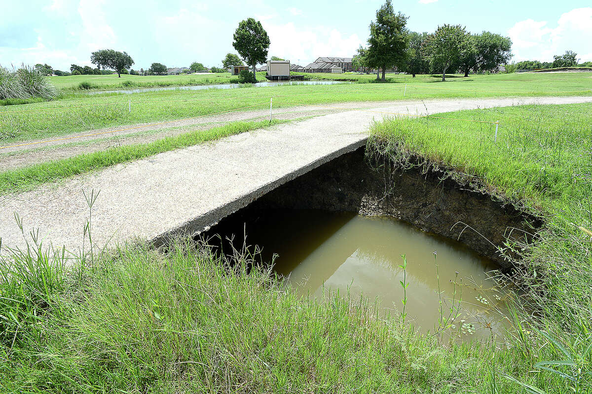 A portion of the throroughfare through the Babe Zaharias Memorial Golf Course is closed off after a broken drainage pipe led to a massive sinkhole opening up beneath the pavement. Problems at the course are among the repair issues facing the Port Arthur City Council as they seek to address the flooding and drainage problems throughout the city. The pipes running through the course haven't been replaced since the facility was built 50 years ago and several have broken, creating overflow to retention ponds and opening sinkholes at spots throughout the course. Friday, August 10, 2018 Kim Brent/The Enterprise