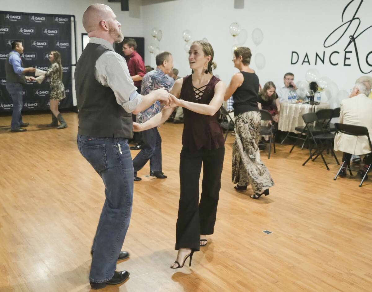 Dance patrons take to the floor at JK Dance Center before owner Kelsey Tanner and Dancing with the Stars dance friend Paul Barris lead a group class 08/10/18 evening during the grand opening of the dance center. Tim Fischer/Reporter-Telegram