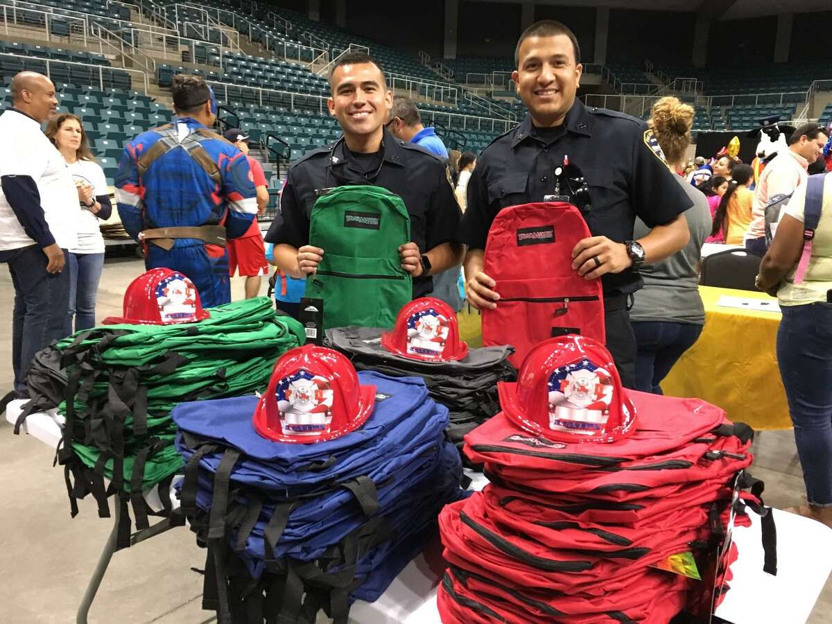 Helping to make sure that youngsters have a good start to the school year were Katy Fire Department firefighters and EMTs Enrique Escobedo and Julio Garcia. In addition to picking their favorite backpack, youths also could choose a fire helmet.