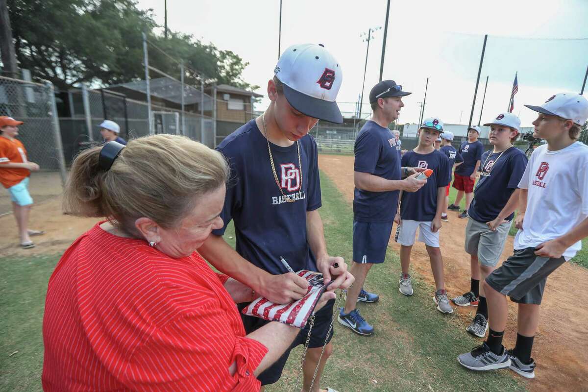 Post Oak Little League team Ryan Selvaggi signs Kay Clinton's purse in advanced to the Little League World Series Thursday, Aug. 9, 2018, in Houston.